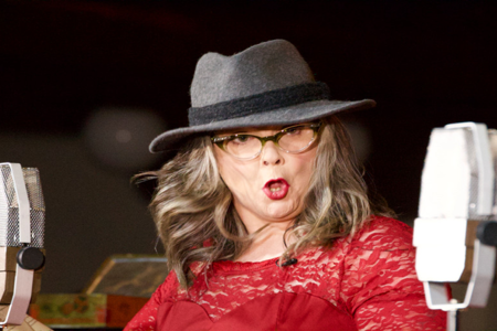 Leonna McGilligan with a microphone either side of her