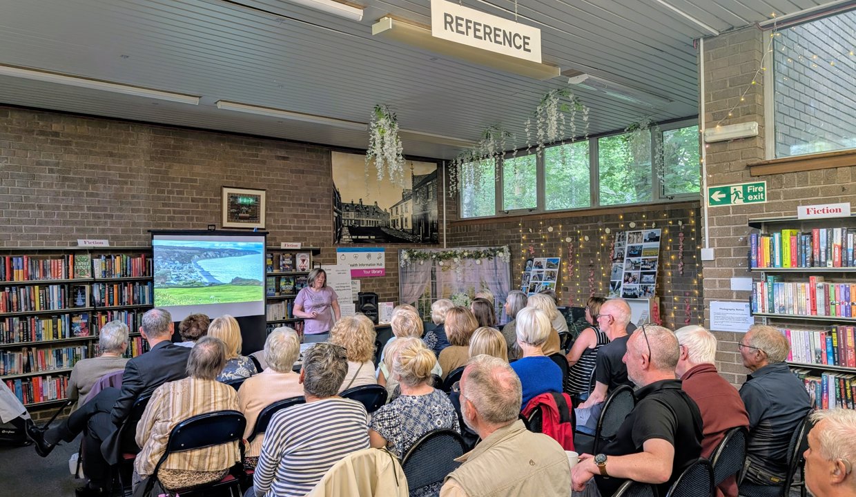 Group of people watching a presentation while seated