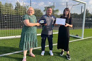 Stuart with Provost Renwick and Depute Provost McDiarmid on a football pitch