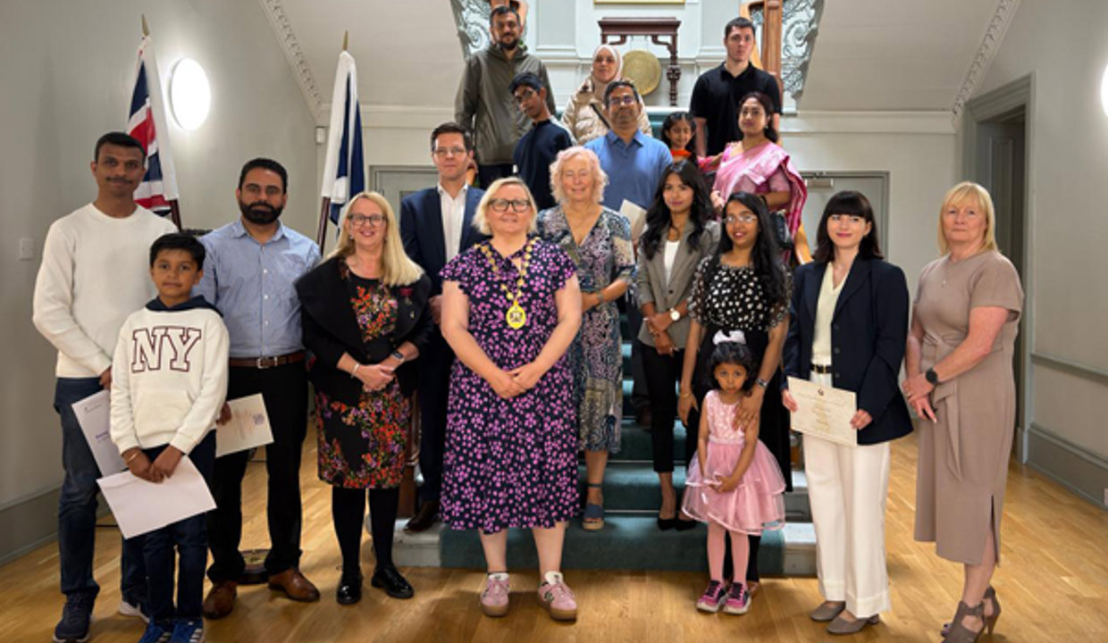 Provost Renwick with the new citizens at Kilmardinny House