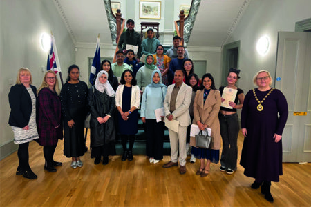 Provost Renwick pictured with new citizens at the ceremony in Kilmardinny House