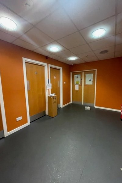 main hall with orange walls and white skirting