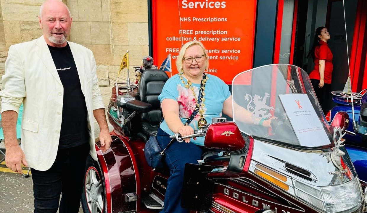 Provost Renwick tries out a classic motorbike at the BIG Weekend