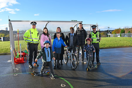 Headteachers of St Matthew’s Primary School and Wester Cleddens Primary School. Also in pictured are two members of the Community Police team and two pupils from each school posing with scooters and bicycles.