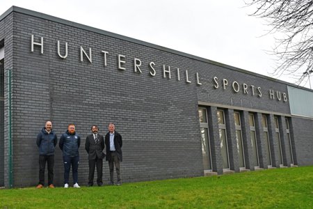 Pictured outside Huntershill Sports Hub are: EDLC Operations Manager Fraser Makeham; Michael Lee, Manager of West Park United FC's men's senior team; Councillor Gordan Low, Leader of the Council; and Councillor Jim Gibbons, Vice Chair of EDLC Trust.