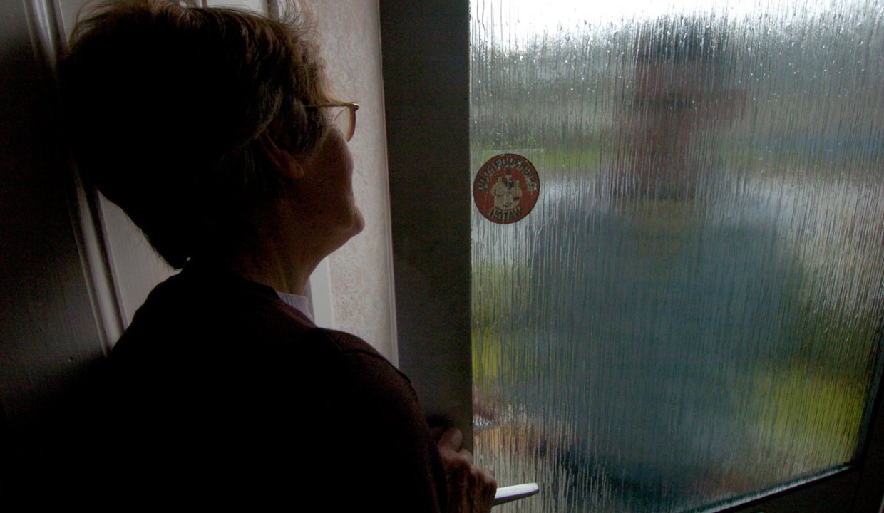 Woman at open door with person on door step