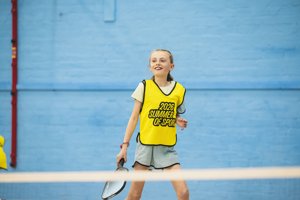 A young girl plays on a sports court