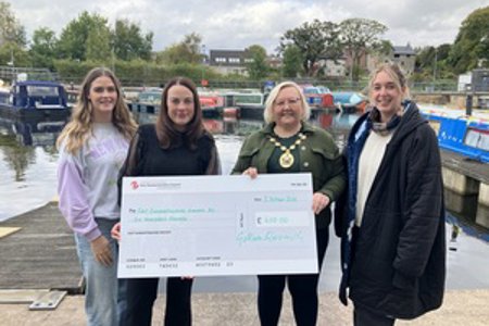 Amy Smith (left) and Sharlene Thurgood (right) from East Dunbartonshire Women’s Aid receiving a cheque for £600 from Depute Provost McDiarmid and Provost Renwick at the marina in Kirkintilloch.