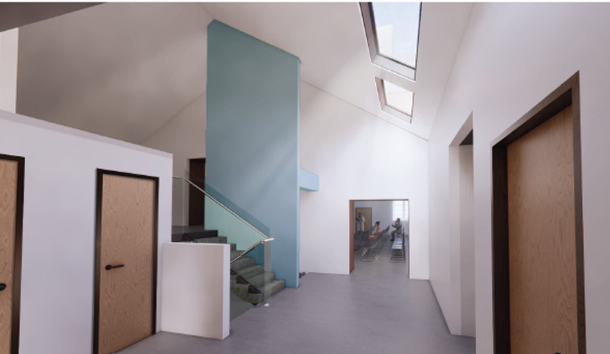 An image of how the foyer inside of the new Campsie Memorial Hall will look showing an open plan corridor with velux windows leading to a hall. 