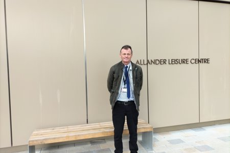 Cllr Jim Gibbons, EDLCT Chair, standing outside the Allander Leisure Centre in Bearsden