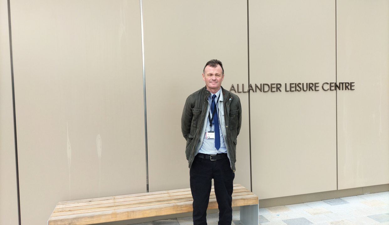 Cllr Jim Gibbons, EDLCT Chair, standing outside the Allander Leisure Centre in Bearsden