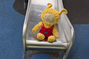 fluffy toy sitting on a metal slide