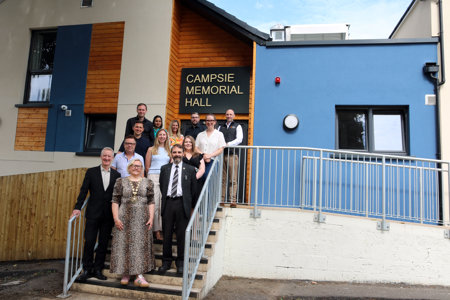 The Provost and Leader of East Dunbartonshire Council pose outside the front door of the newly refurbished Campsie Memorial Hall with project partners. 