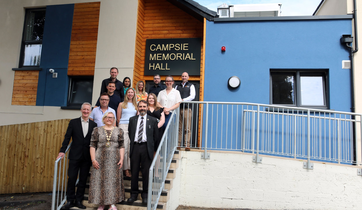 The Provost and Leader of East Dunbartonshire Council pose outside the front door of the newly refurbished Campsie Memorial Hall with project partners. 