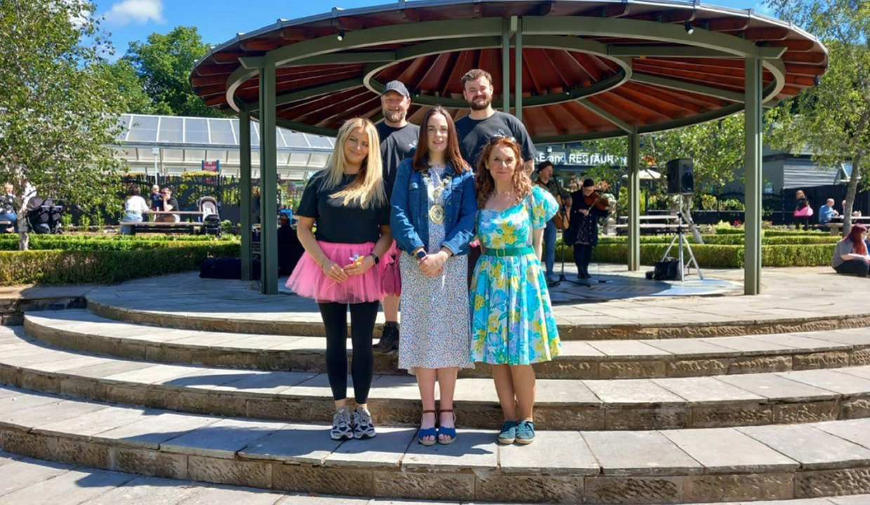 Depute Provost McDiarmid is pictured in front of the bandstand in the walled garden with some of the Mugdock Country Park team.