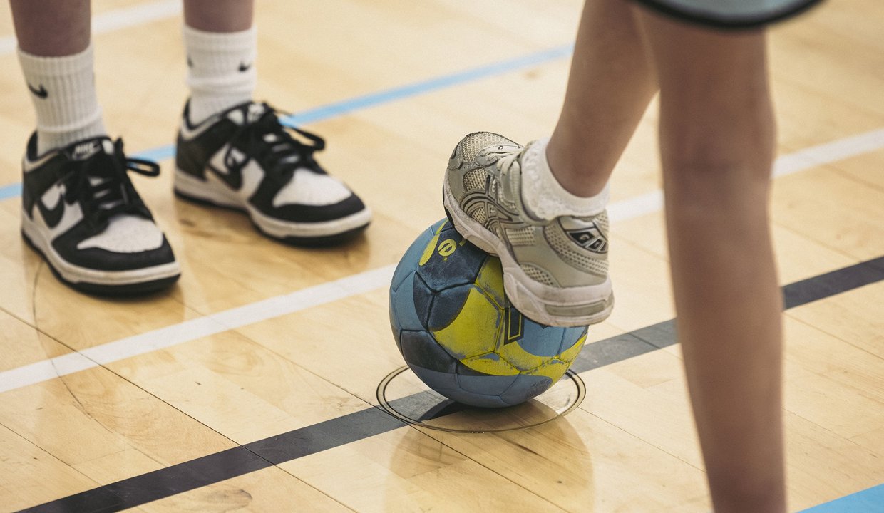 A young person with a foot on a ball as part of the ‘Summer of Sport’