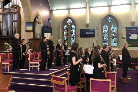 The orchestra and conductor take a bow